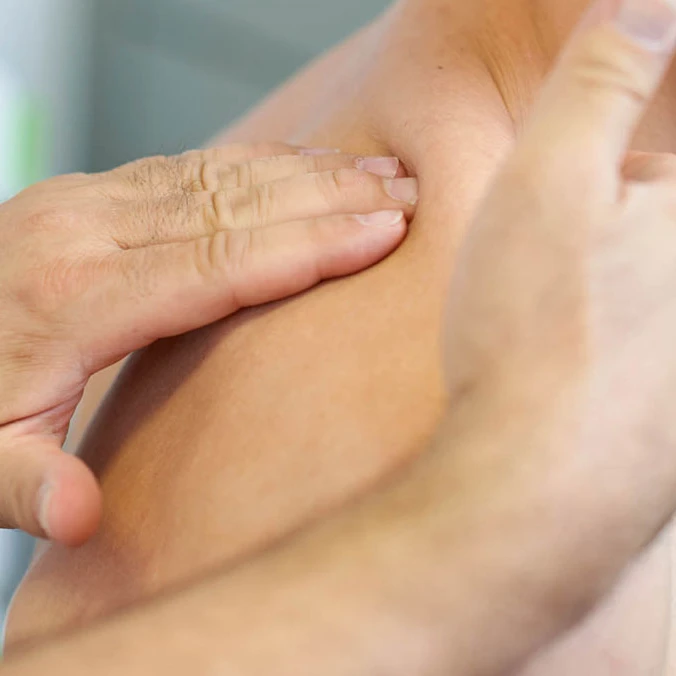 Manuelle Therapie am Rücken eines Patienten